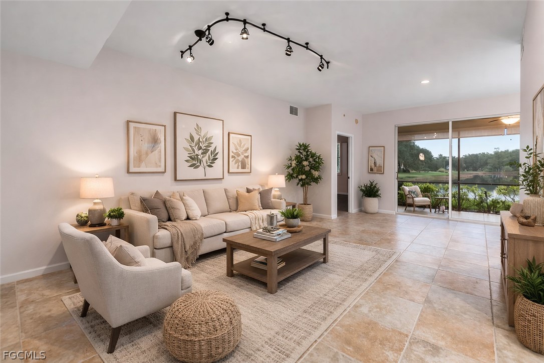 13110 Pebblebrook Point Circle, Unit 102 Fort Myers, FL 33905 - Photo 6 of 35 a living room with furniture and a floor to ceiling window