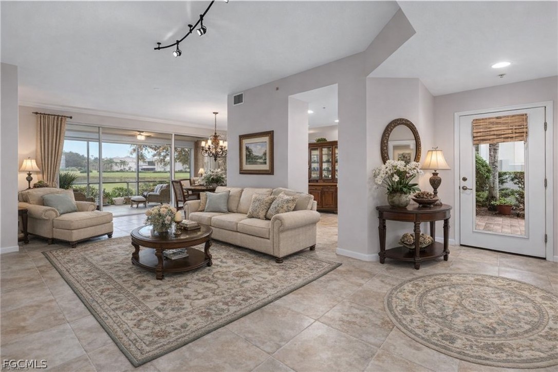 13110 Pebblebrook Point Circle, Unit 102 Fort Myers, FL 33905 - Photo 8 of 35 a living room with furniture and a large window