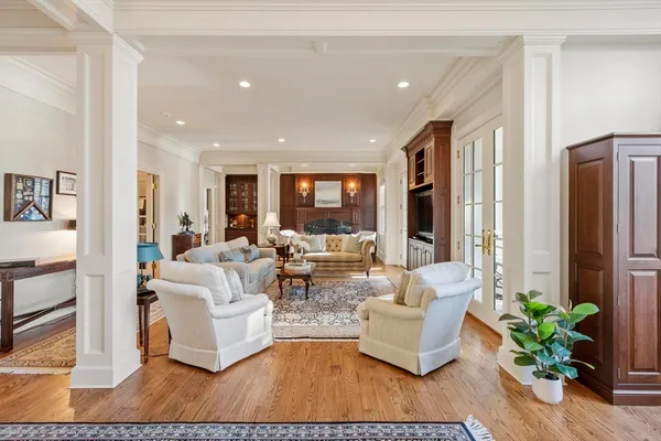 a living room with furniture potted plant and a large window