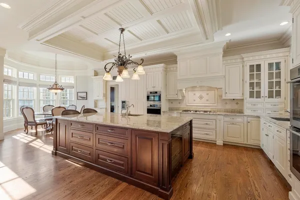 a open kitchen with stainless steel appliances granite countertop a lot of counter space and wooden floors