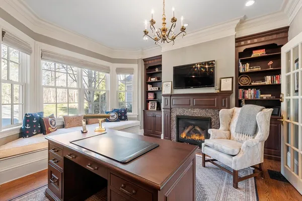 a living room with furniture fireplace and flat screen tv