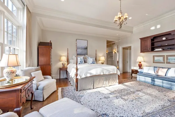 a spacious bedroom with bed and a chandelier