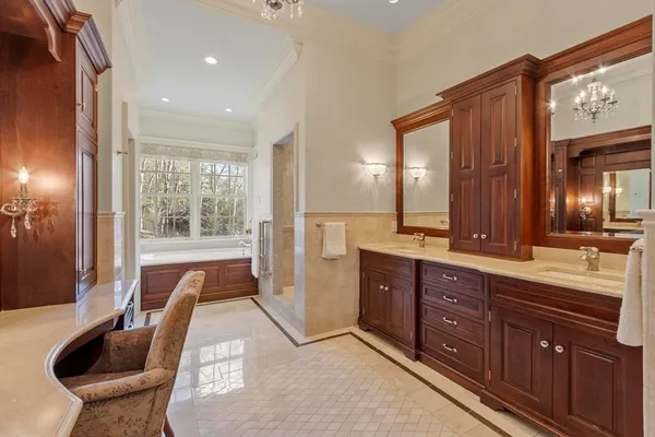 a spacious bathroom with a granite countertop tub sink and mirror
