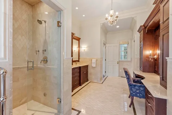 a large bathroom with a glass shower door a sink and a mirror