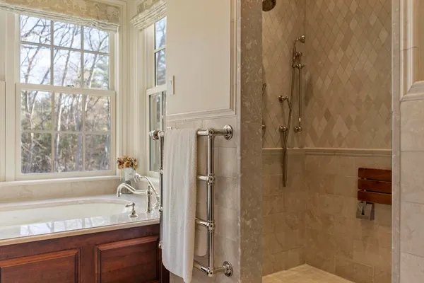 a bathroom with a bathtub and a shower