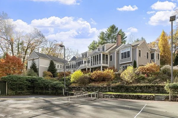 a view of a white house with a yard and plants
