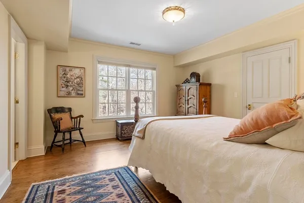 a bedroom with a bed a table and chair