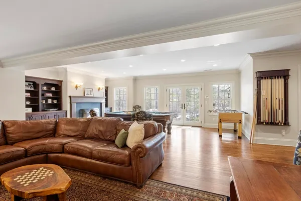 a living room with furniture wooden floor and a large window