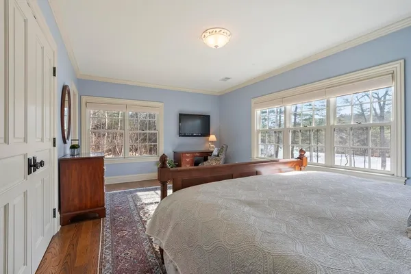 a large bedroom with a large bed and a large window