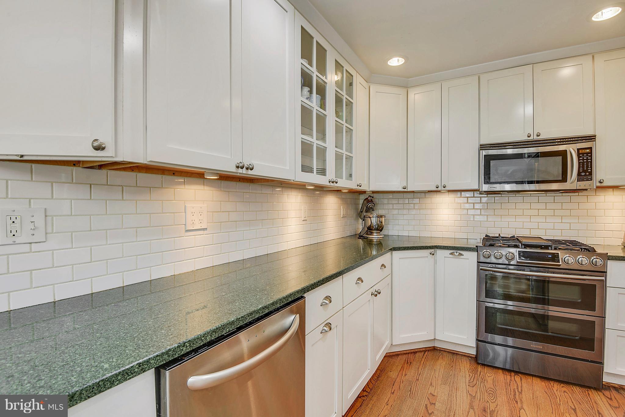 1912 Lansdowne Way Silver Spring, MD 20910 - Photo 14 of 28 a kitchen with granite countertop cabinets stainless steel appliances and wooden floor