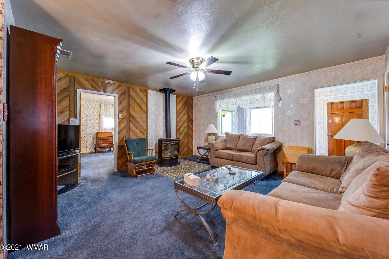 2037 Lumber Valley Road Overgaard, AZ 85933 - Photo 8 of 23 a living room with furniture and a chandelier