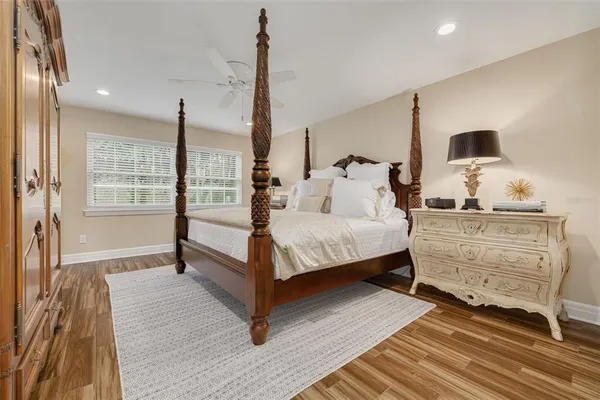 a bedroom with a bed and large window