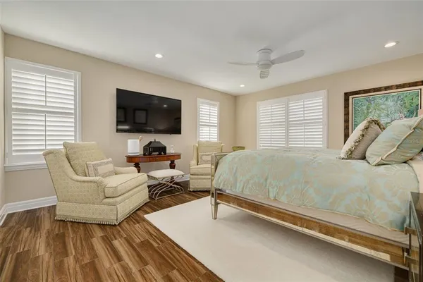 a spacious bedroom with a bed and a flat screen tv