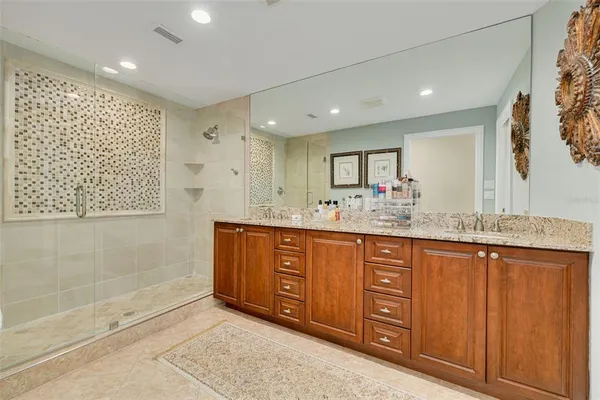 a bathroom with a granite countertop sink mirror and double