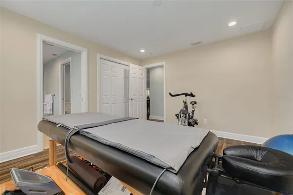 a room with a table chairs and wooden floor
