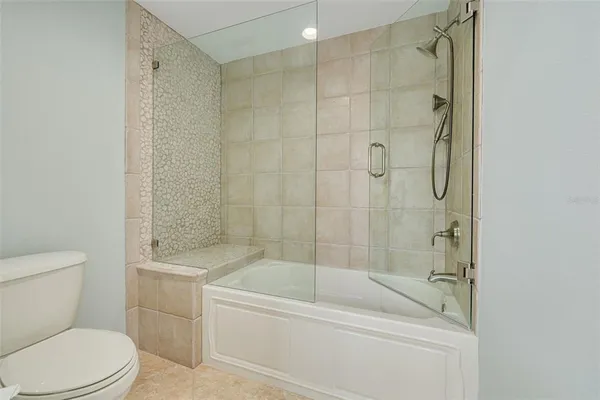 a bathroom with a toilet and a bathtub