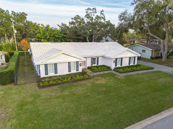 a aerial view of a house with a yard table and chairs