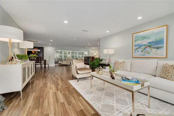 a living room with furniture and wooden floor