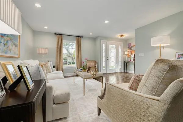 a living room with furniture and a wooden floor