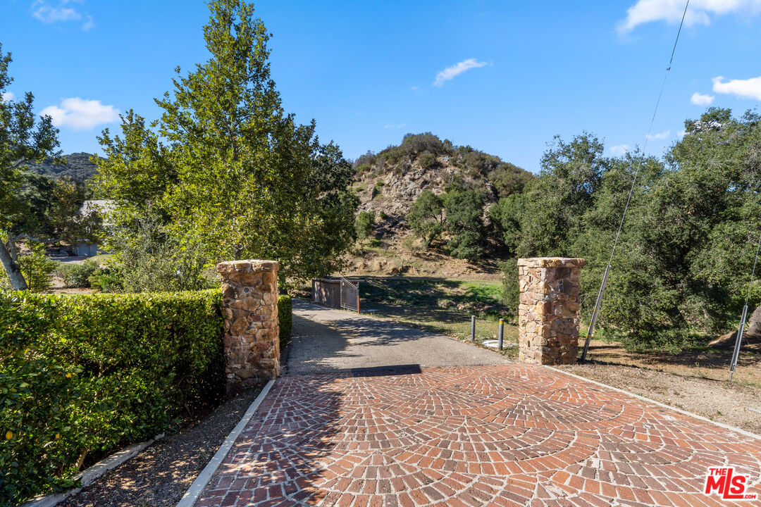 a view of a pathway with a wooden fence