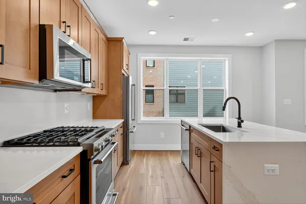 a kitchen with a sink and a stove top oven