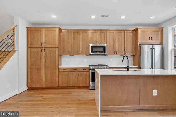 a kitchen with stainless steel appliances granite countertop a refrigerator sink and cabinets