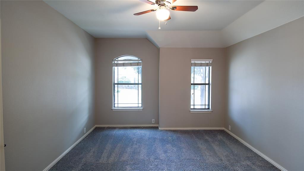 8698 Fisher Road Frisco, TX 75033 - Photo 20 of 33 an empty room with windows and chandelier fan