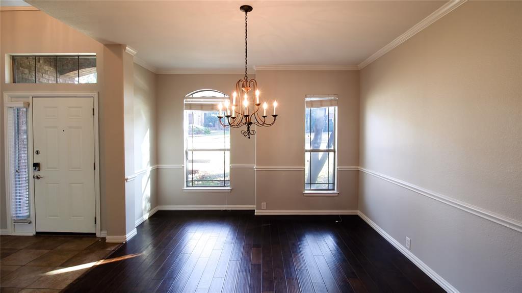 8698 Fisher Road Frisco, TX 75033 - Photo 5 of 33 a view of an empty room with wooden floor and a window