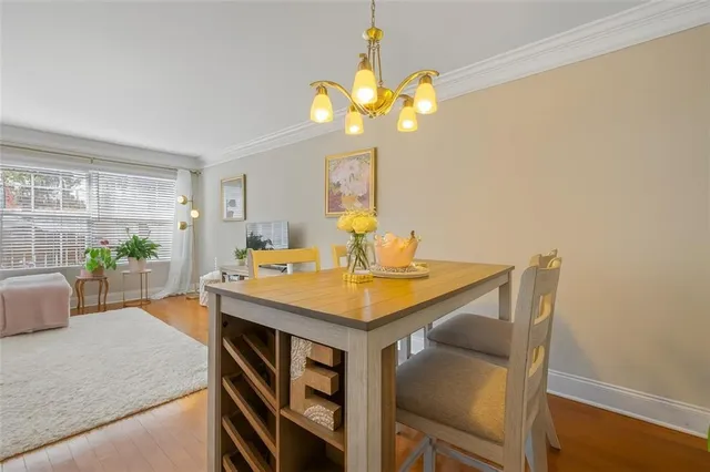a view of kitchen island with granite countertop cabinets table and chairs