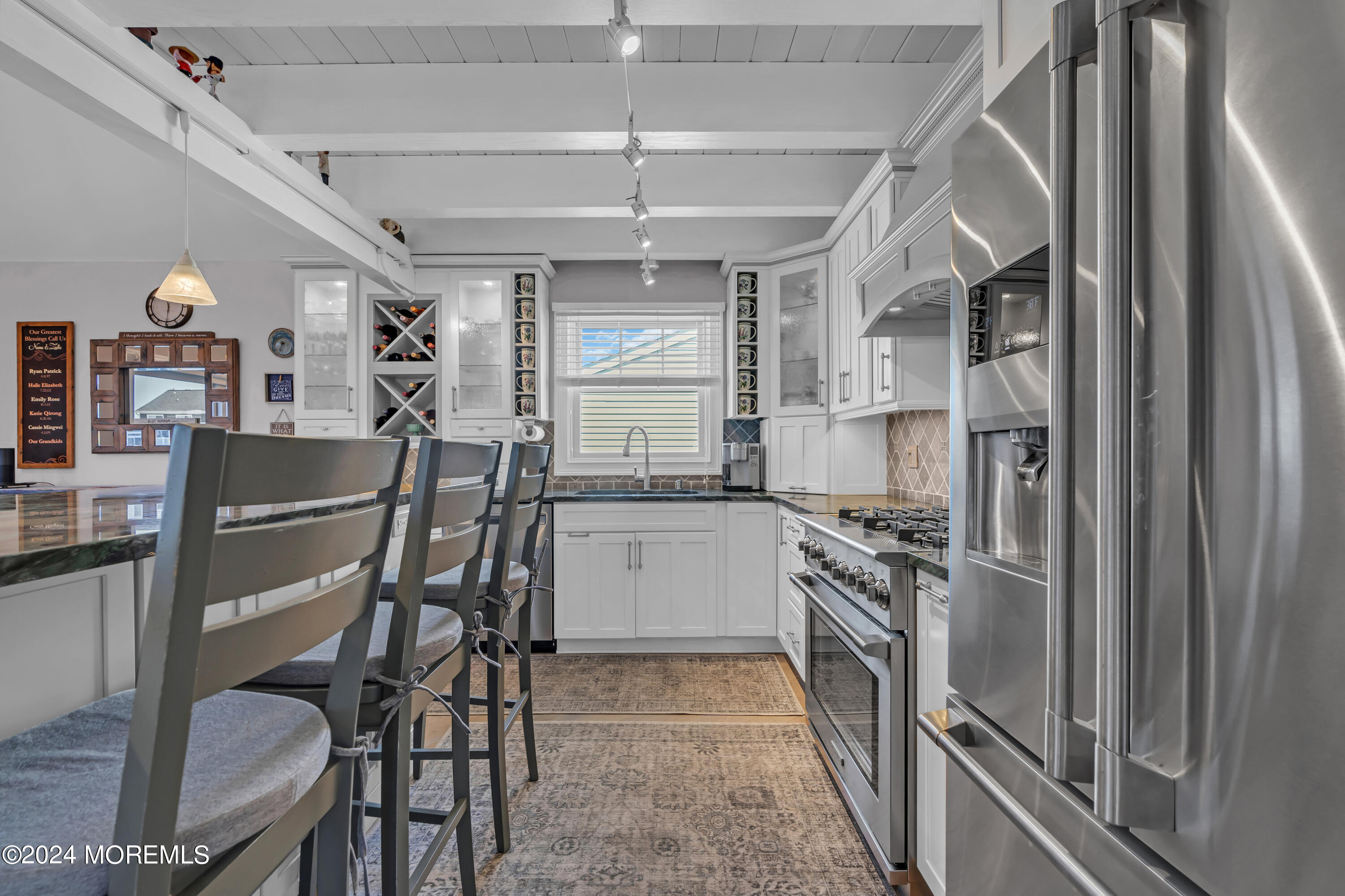 381 Aldo Drive Toms River, NJ 08753 - Photo 13 of 58 a kitchen with a table chairs refrigerator and cabinets
