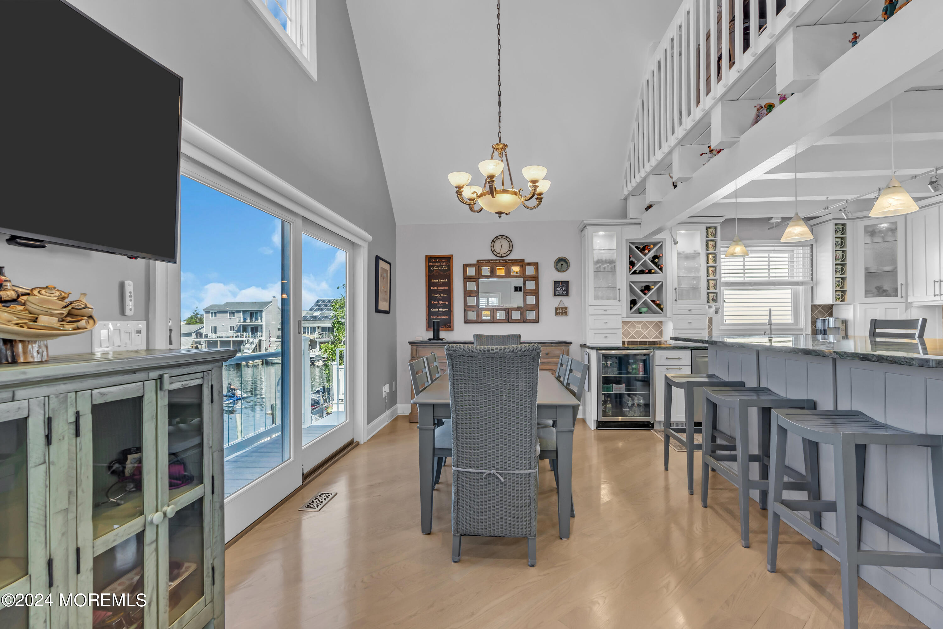 381 Aldo Drive Toms River, NJ 08753 - Photo 15 of 58 a kitchen with stainless steel appliances kitchen island granite countertop a table chairs in it and wooden floors