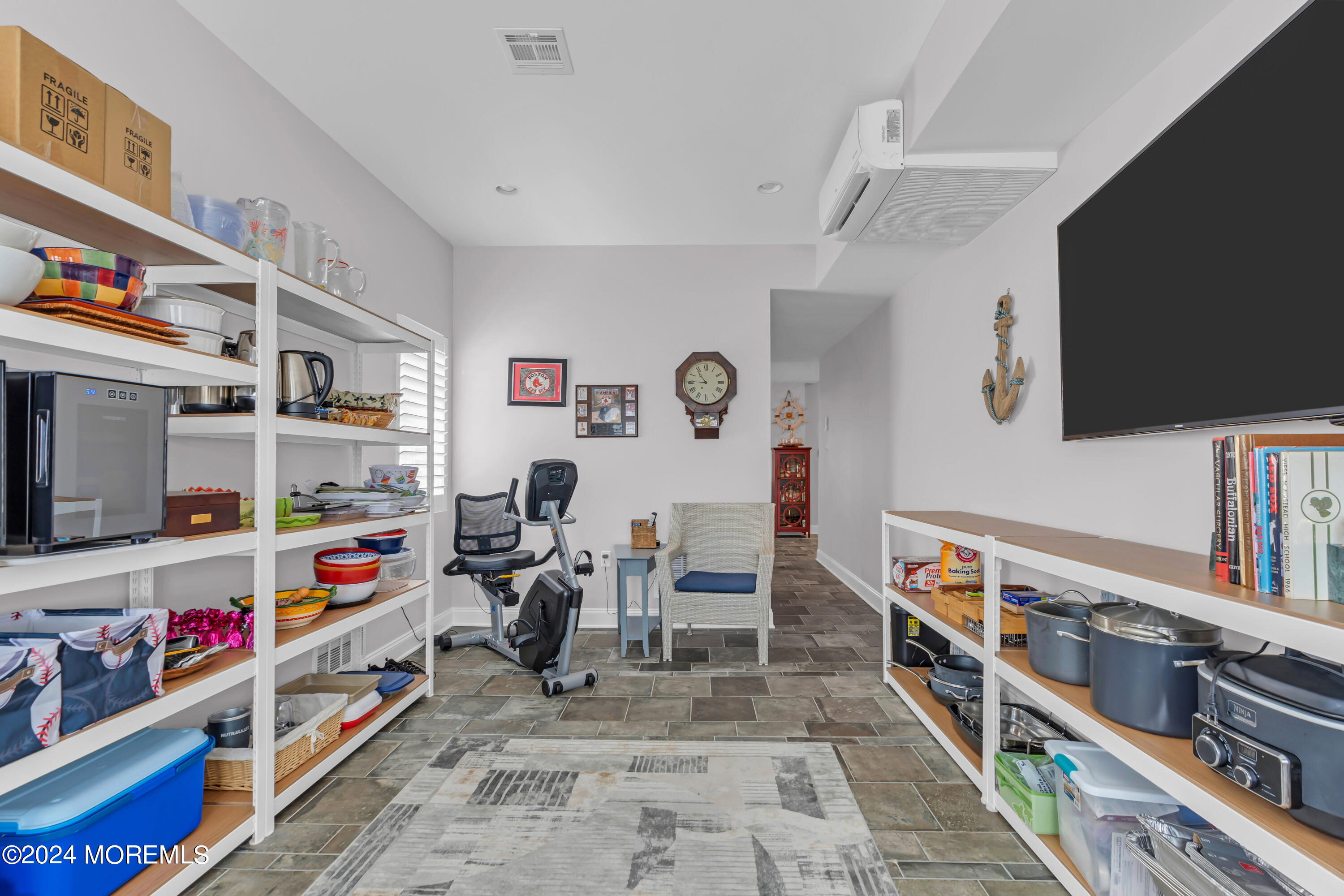 381 Aldo Drive Toms River, NJ 08753 - Photo 38 of 58 a room with furniture a flat screen tv and a book shelf