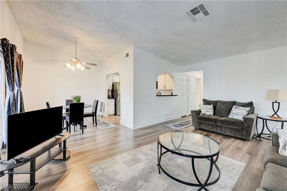 1751 East Reno Avenue, Unit 228 Las Vegas, NV 89119 - Photo 39 of 39 An open floor plan seamlessly connects the comfortable living space with a dining area, featuring sloped ceilings.