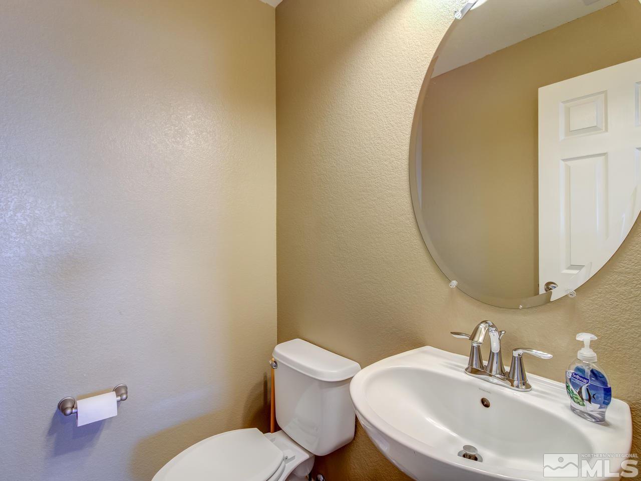 9055 Convair Way Reno, NV 89506 - Photo 11 of 24 a bathroom with a sink mirror and toilet