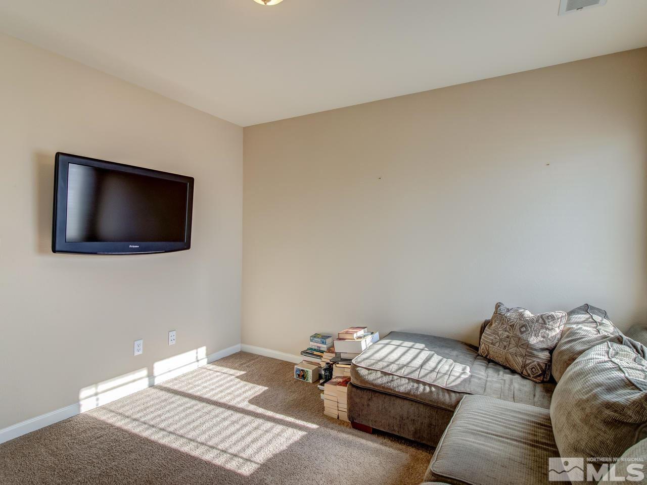 9055 Convair Way Reno, NV 89506 - Photo 16 of 24 a bedroom with a bed and a flat screen tv