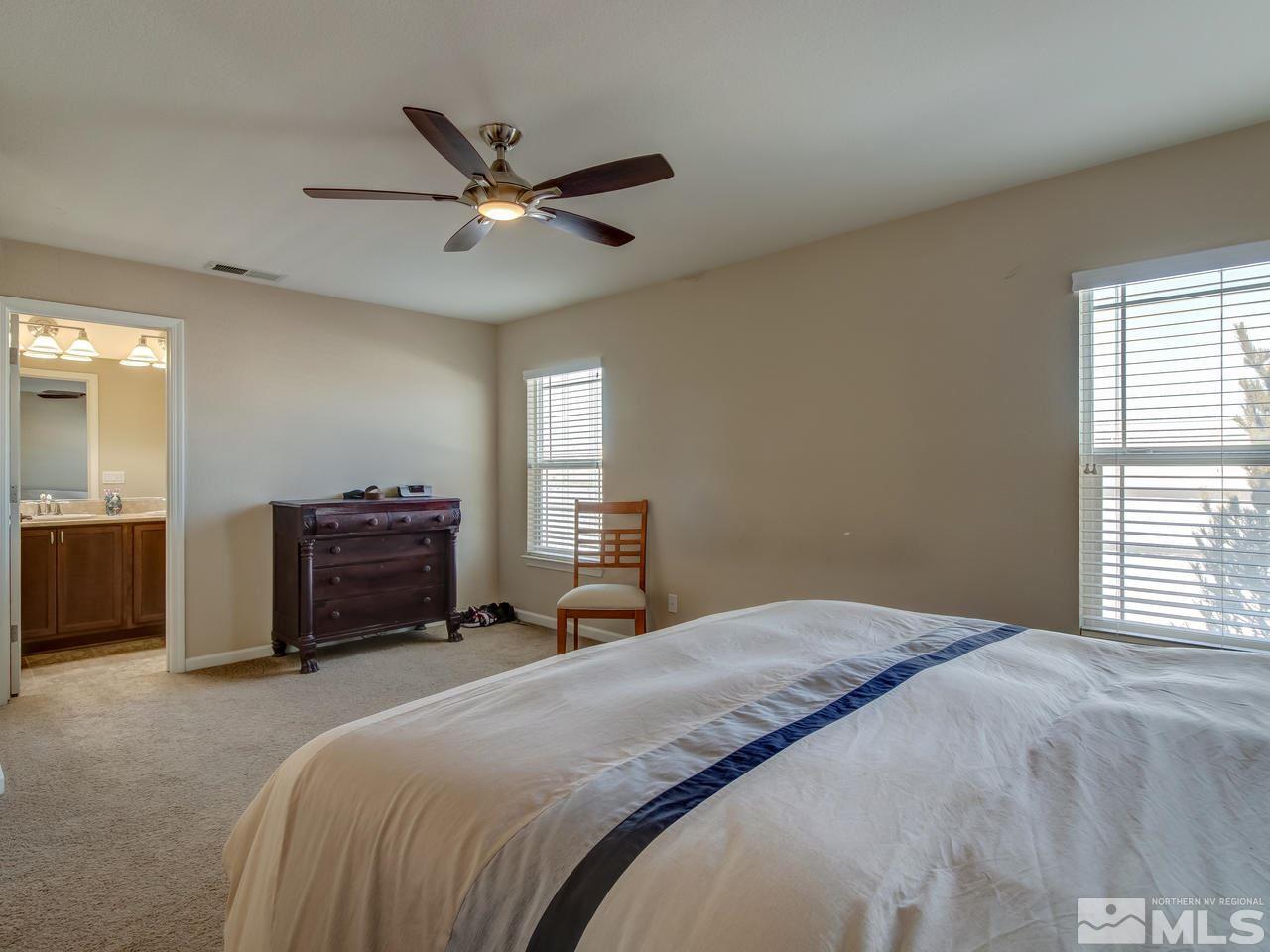 9055 Convair Way Reno, NV 89506 - Photo 19 of 24 a bedroom with a bed and a chandelier