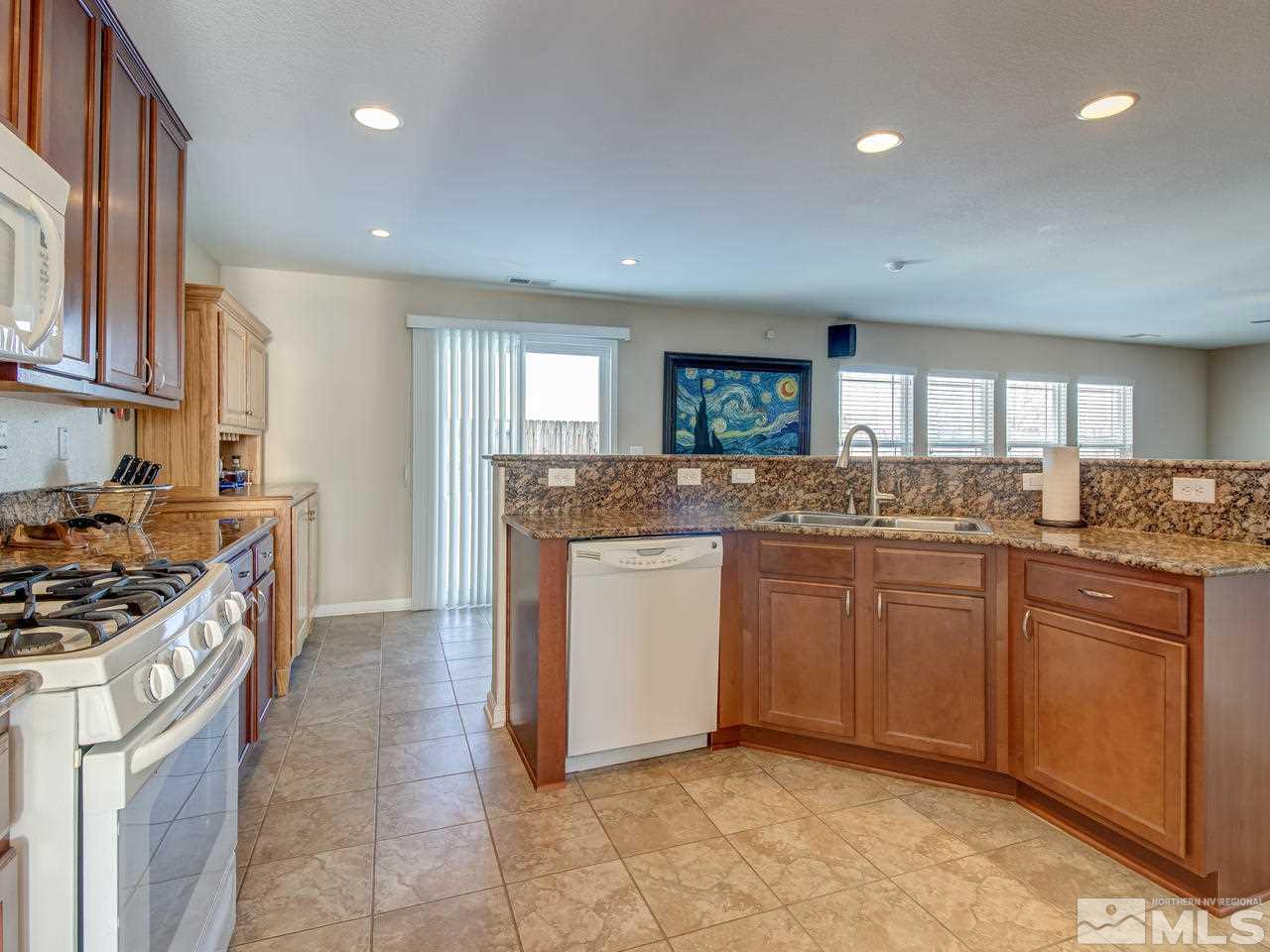 9055 Convair Way Reno, NV 89506 - Photo 6 of 24 a kitchen with granite countertop cabinets stainless steel appliances a sink and a counter top space