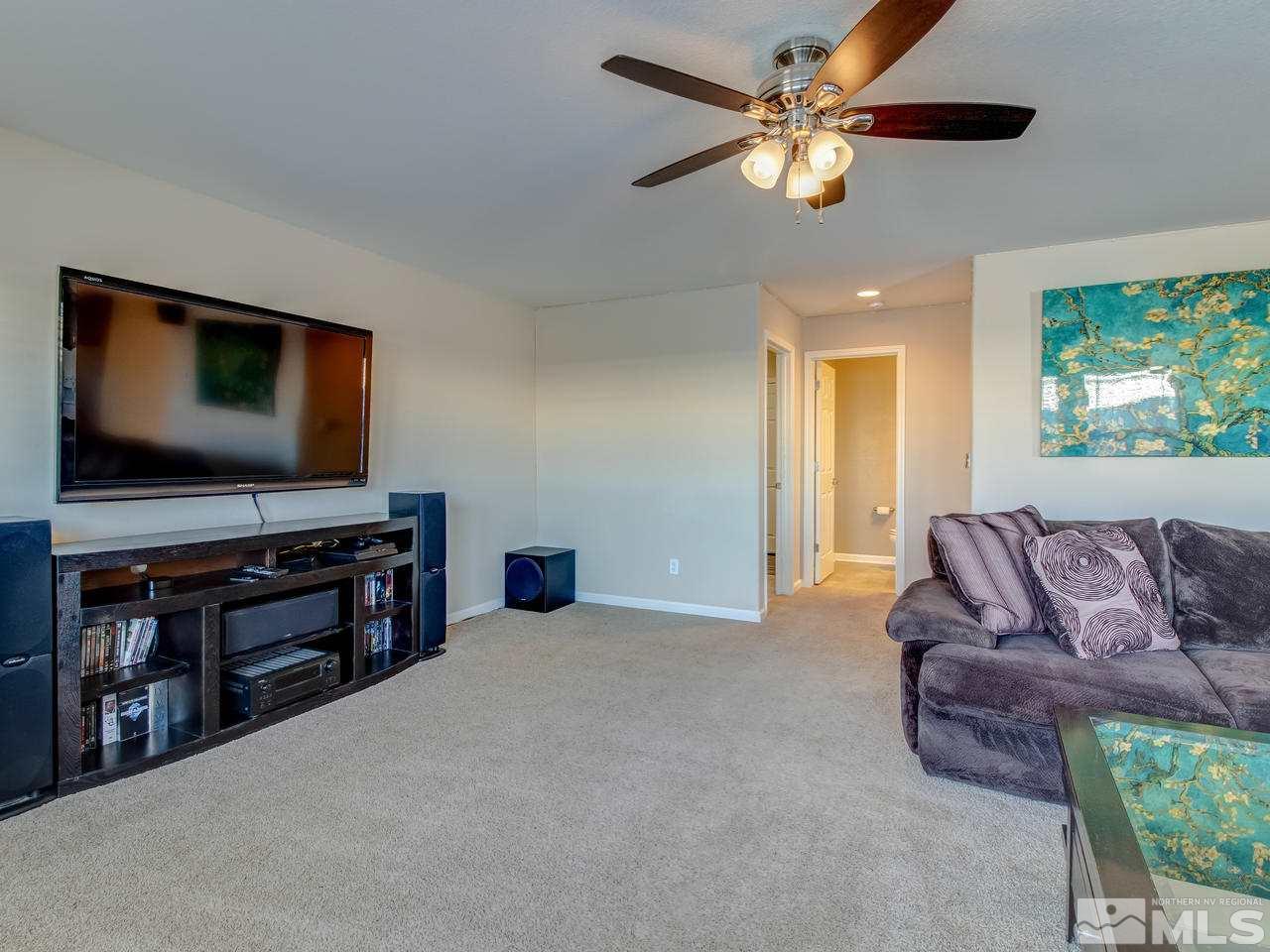 9055 Convair Way Reno, NV 89506 - Photo 9 of 24 a living room with furniture and a flat screen tv