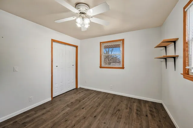 a view of an empty room with wooden floor