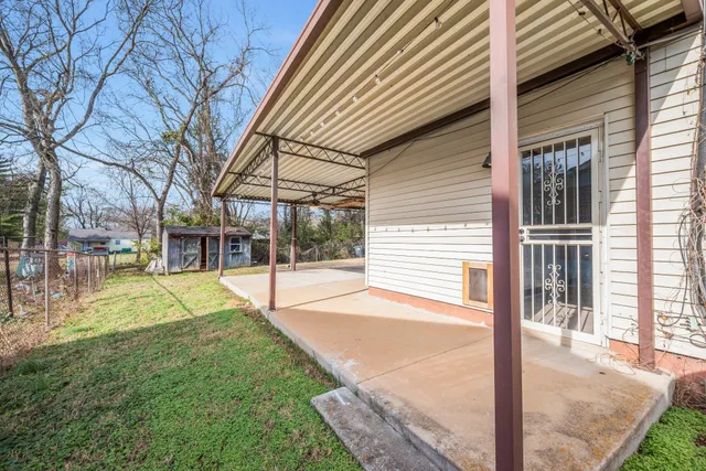 a view of a house with a yard and tree s
