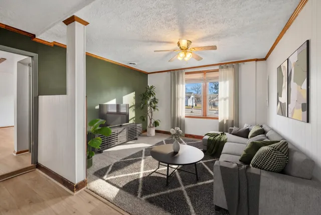 a living room with furniture and a chandelier