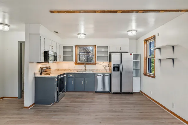 a kitchen with stainless steel appliances granite countertop a refrigerator and a sink