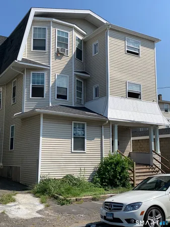 a front view of a house with parking space