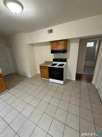 a view of kitchen with microwave and cabinets
