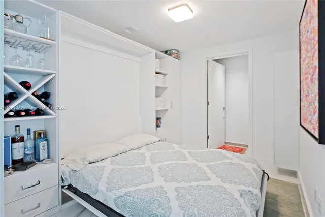 a bedroom with a bed and the view of bathroom