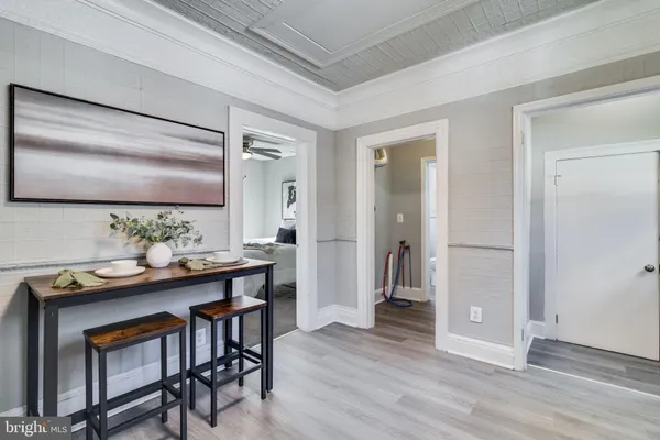 a dining room with furniture and wooden floor