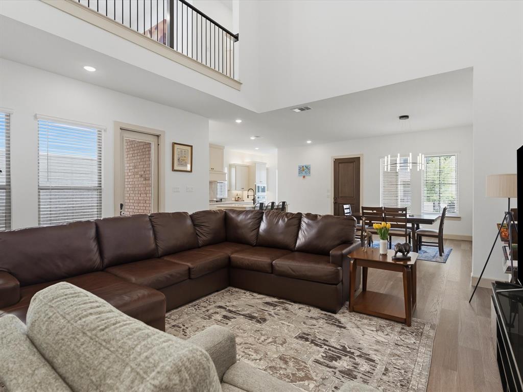 9533 Keep Street Frisco, TX 75035 - Photo 15 of 40 Open-concept living space featuring high ceilings, wood-finish flooring, and recessed lighting