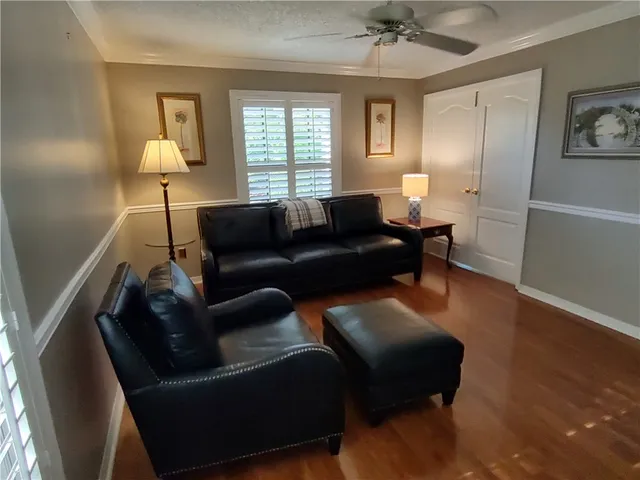 a living room with furniture and wooden floor
