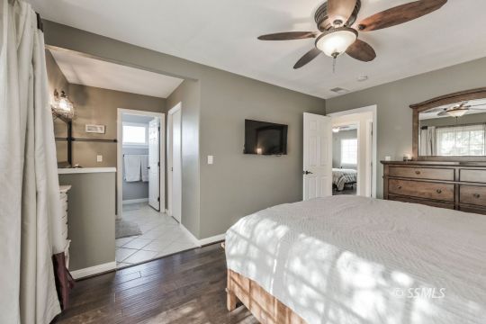 1267 North Erwin Street Ridgecrest, CA 93555 - Photo 20 of 35 a spacious bedroom with a large bed and a chandelier