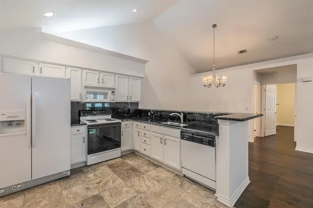a kitchen with stainless steel appliances and white cabinets